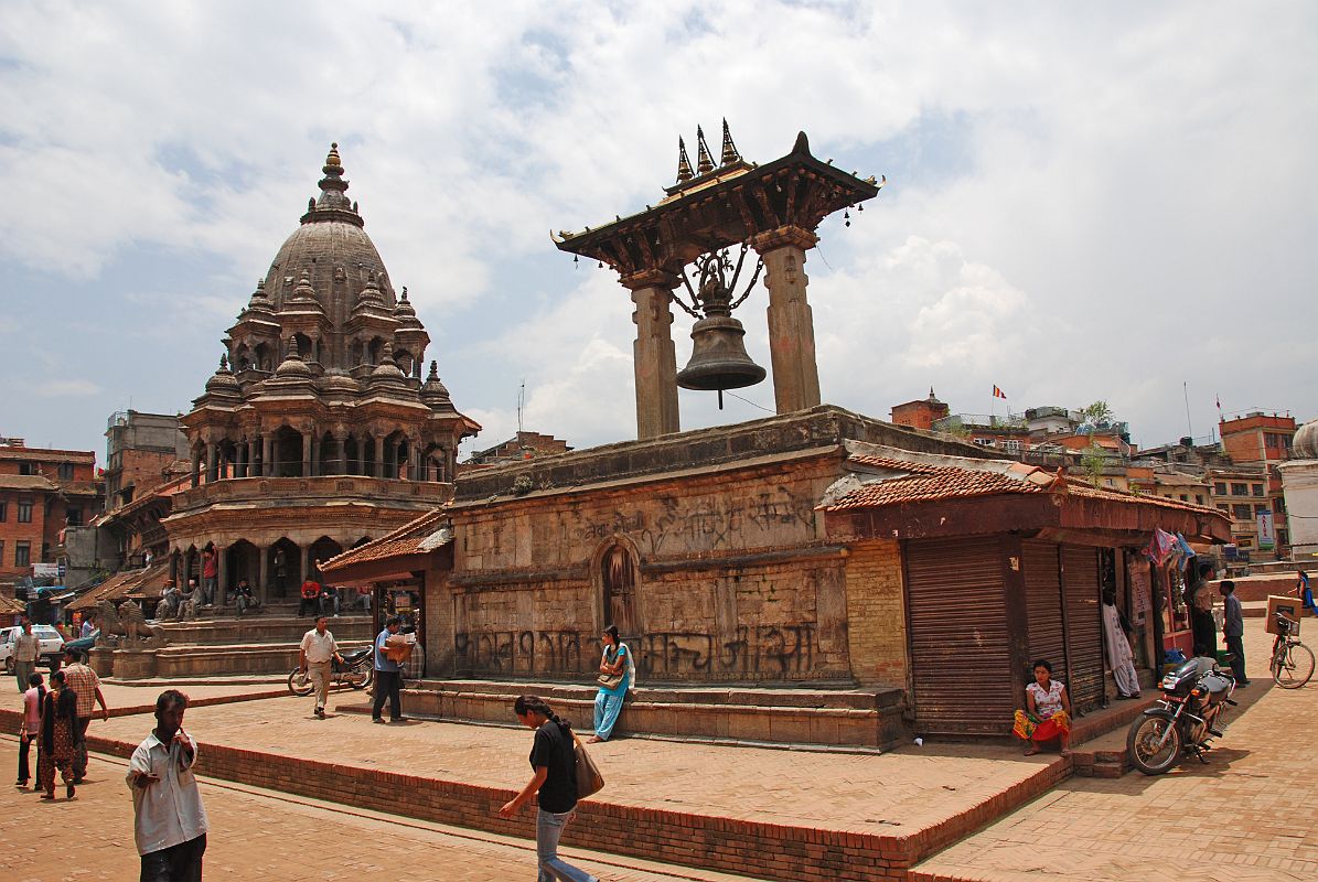 Kathmandu Patan Durbar Square 03 Krishna Temple and Taleju Bell The Krishna Temple (1723) is the octagonal white stone temple as you enter Patan�s Durbar Square from the south. The large bell hanging between two pillars on the right is Taleju Bell (1736).
